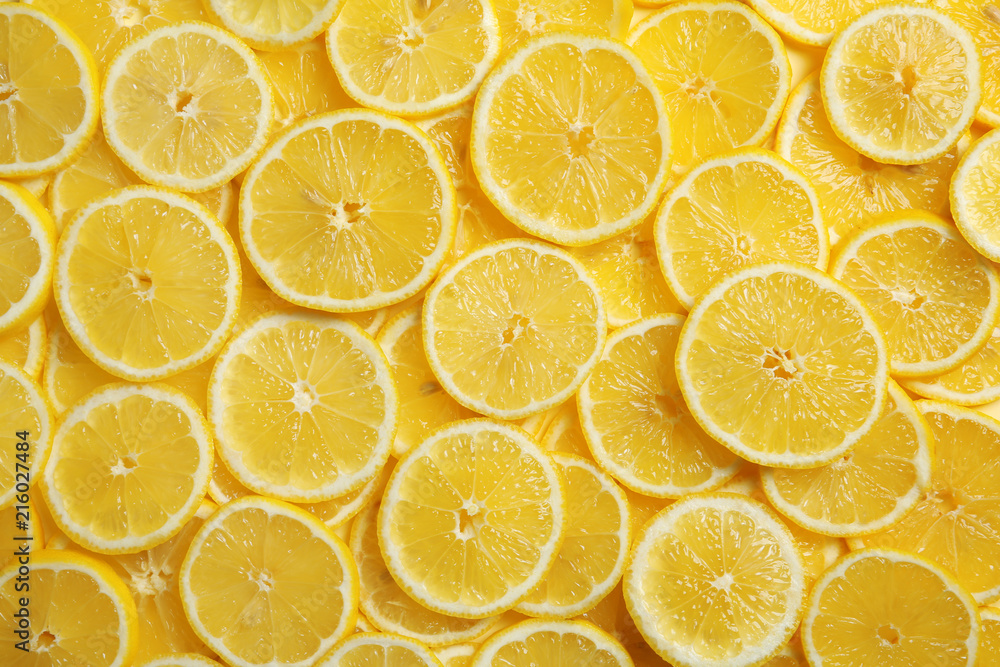 Slices of fresh juicy lemons as background, top view Slices of fresh juicy lemons as background, top view