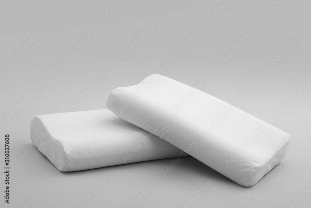 Clean soft orthopedic pillows on grey background Clean soft orthopedic pillows on grey background