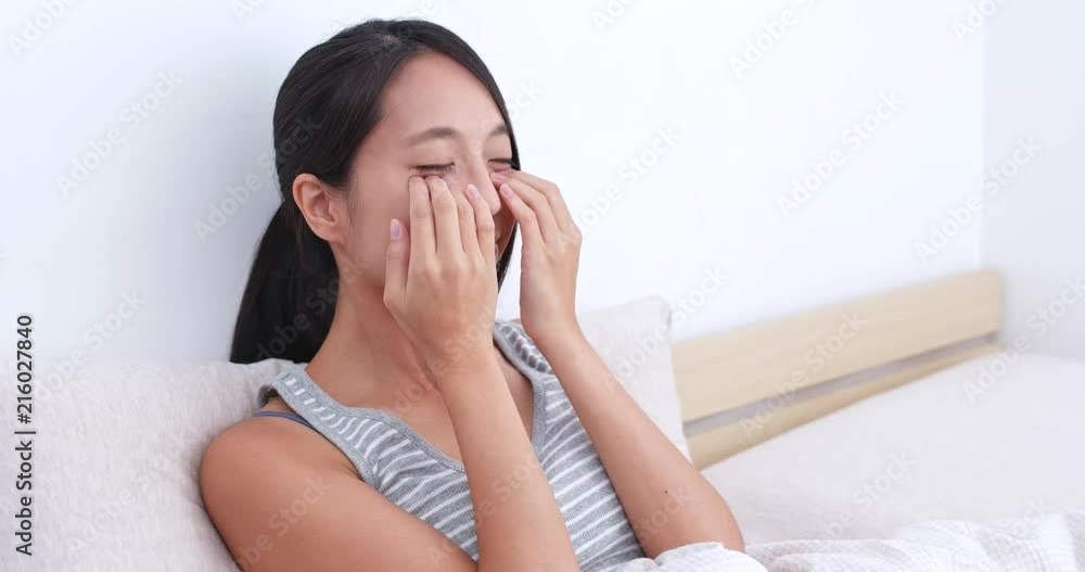 Woman do massaging on her face on bed Woman do massaging on her face on bed