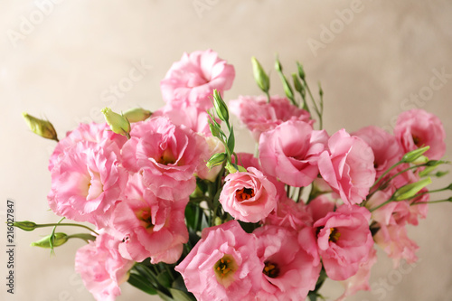 Beautiful bouquet of Eustoma flowers on color background  close up view