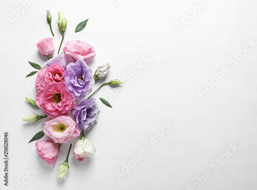 Flat lay composition with beautiful Eustoma flowers on light background © New Africa