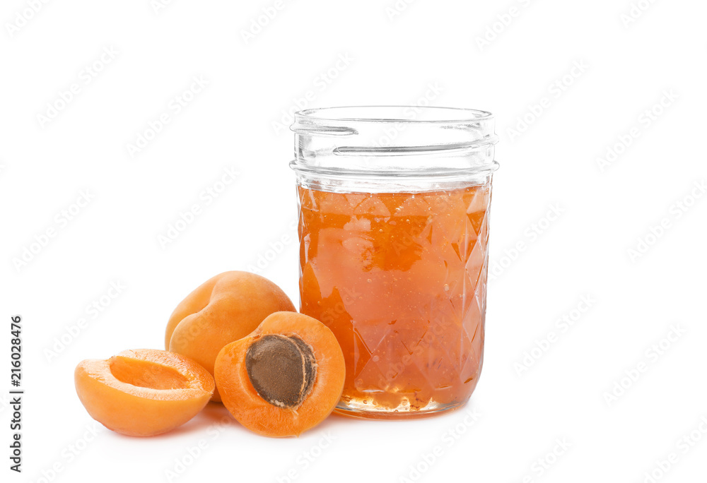Jar with delicious apricot jam and fruit on white background Jar with delicious apricot jam and fruit on white background