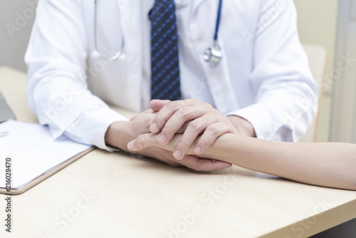 Healthy and medical concept. Doctor holding patient hand to give encourage in hospital.