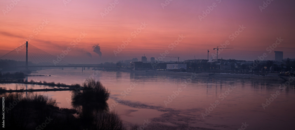 Panorama of Warsaw with the Swietokrzyski bridge in the morning fog of a smoky city