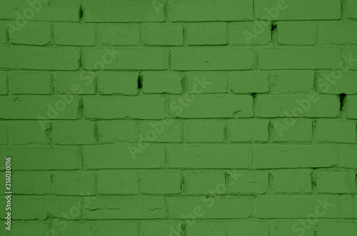 Brick wall of green painted brick. Green brick wall texture.