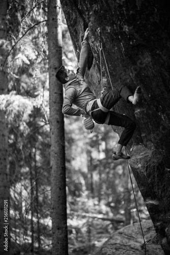 Male climber climbing overhanging rock Outdoor active lifestyle