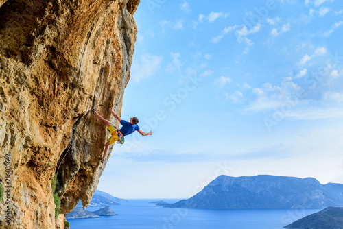 Rock climber on a challenging cliff, extreme sport lifestyle. Travelling Greece photo