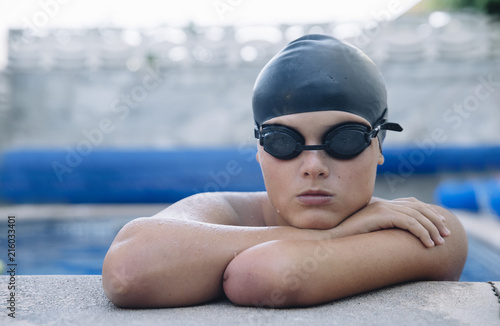 Young boy who does swimming and he lacks an arm, disabled person photo