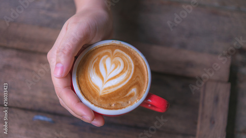 Hand Holding Hot Latte Coffee