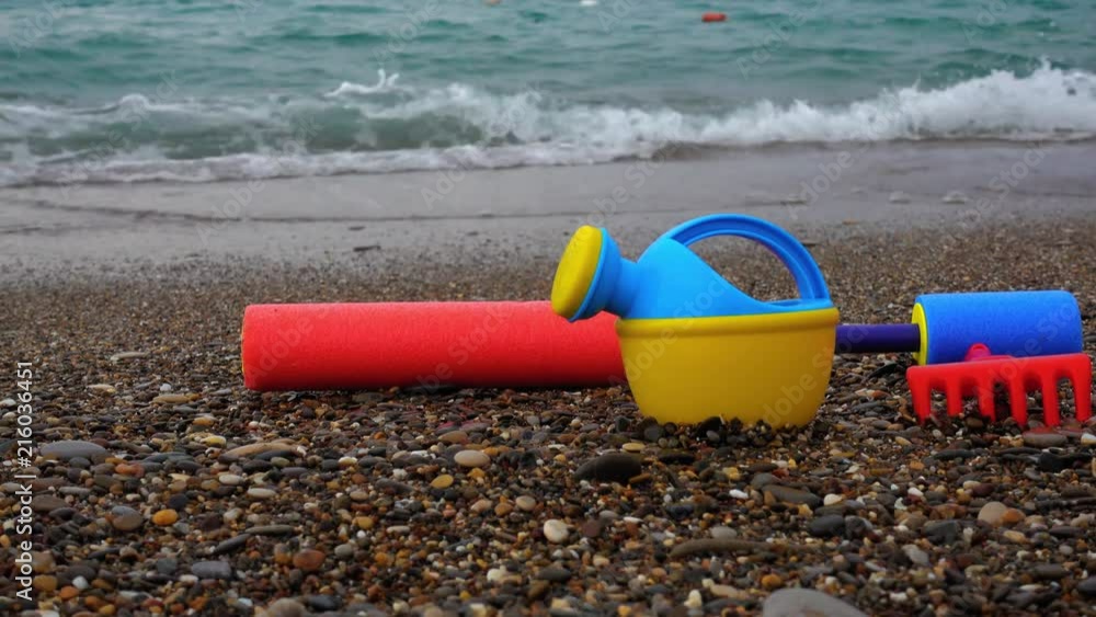 Baby toys are forgotten on the beach. The concept of travel and vacation at sea, a family trip with children. Baby toys are forgotten on the beach. The concept of travel and vacation at sea, a family trip with children.