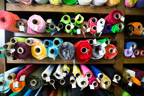 different fabric bolts exposed on shelves