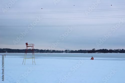 Empty winter beach with lifeguard chair photo