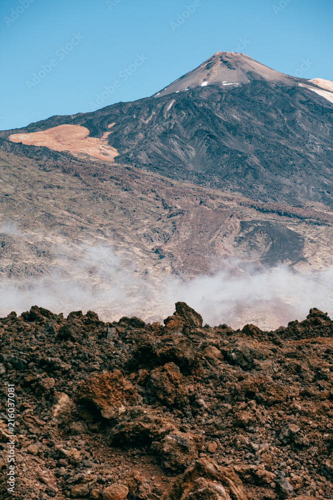 Highest point of Spain with volcano lava leftovers and mist , Mount Teide, Tenerife