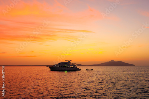Yacht in the rays of the setting sun against the island of Tirana. Red sea. Egypt. © Artur