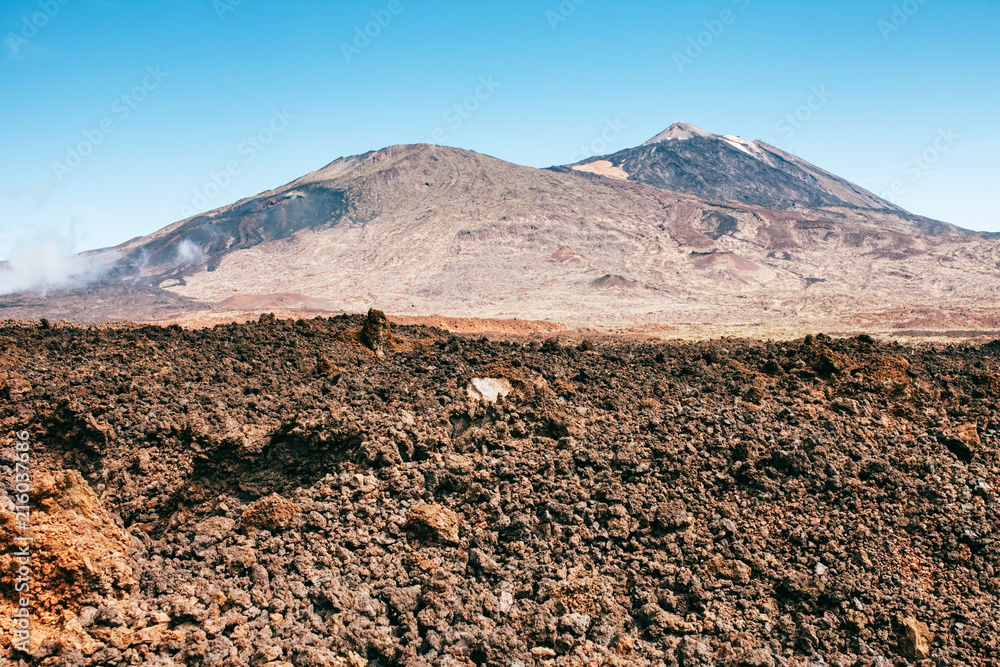 Sunny landscape of highest point of Spain with volcano and lava leftovers , Mount Teide, Tenerife
