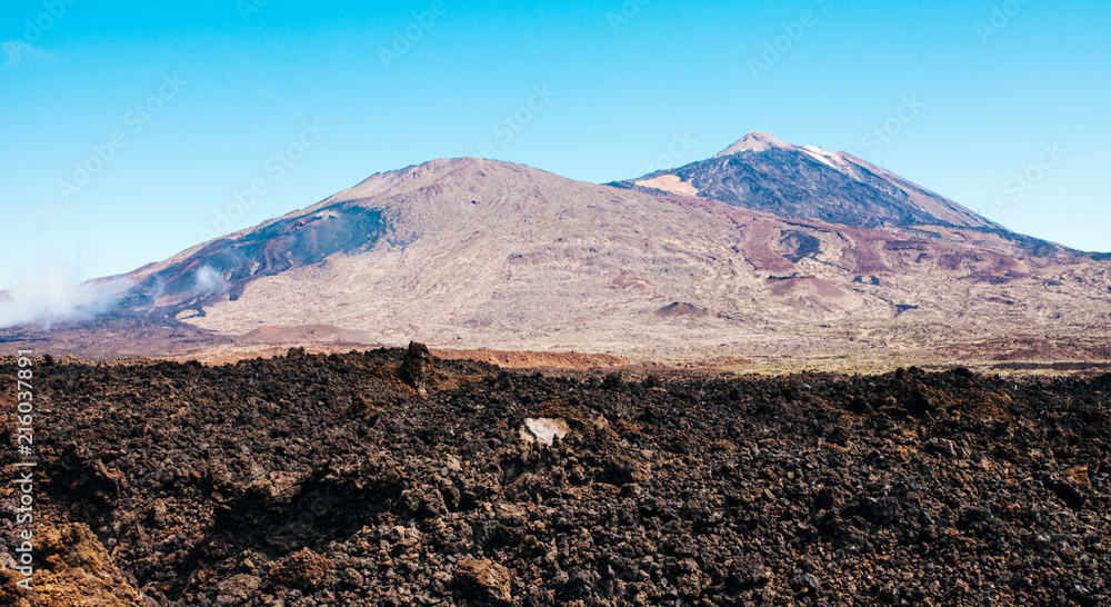 Sunny landscape of highest point of Spain with volcano and lava leftovers , Mount Teide, Tenerife