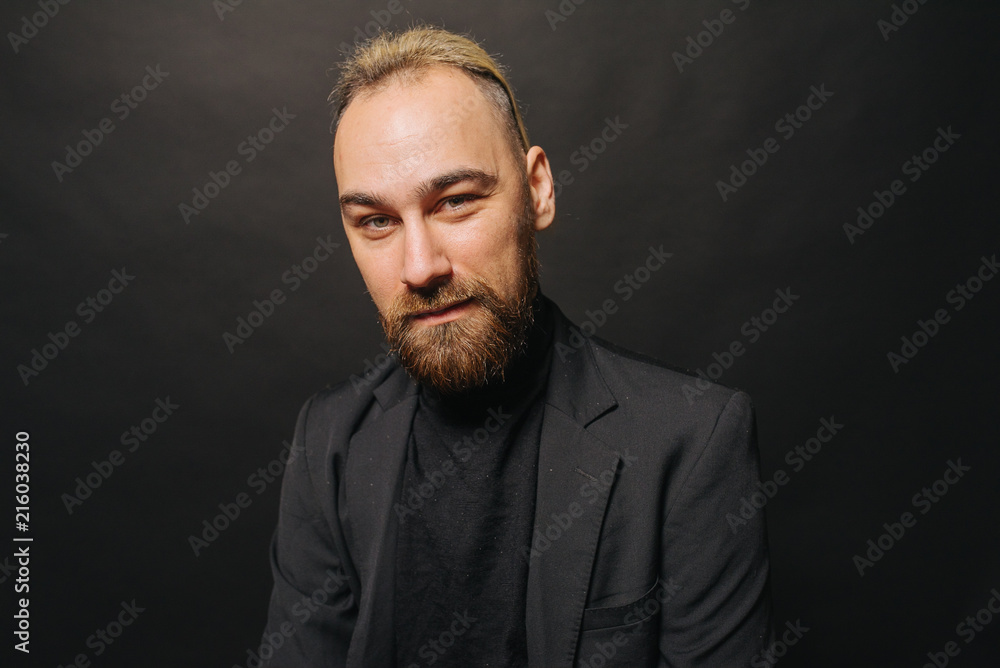 Elegant handsome man in classical suit poses in studio theatre. Elegant handsome man in classical suit poses in studio theatre.