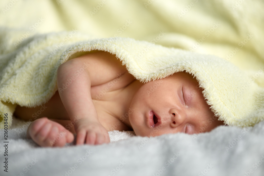 Newborn baby boy portrait on white carpet closeup. Motherhood and new life concept Newborn baby boy portrait on white carpet closeup. Motherhood and new life concept