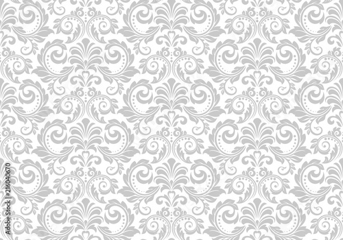 Wallpaper in the style of Baroque. Seamless vector background. White and grey floral ornament. Graphic pattern for fabric, wallpaper, packaging. Ornate Damask flower ornament.