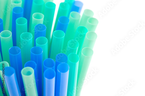 Green and Blue Plastic Straws on a White Background