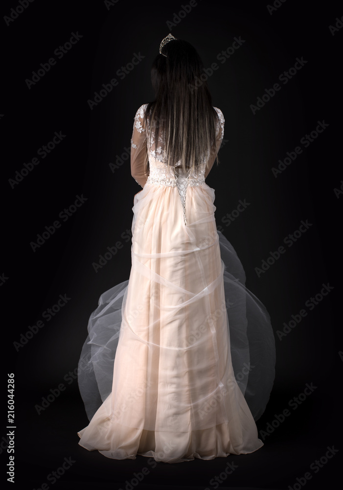 Full length of a beautiful bruenette woman in wedding dress Full length of a beautiful bruenette woman in wedding dress