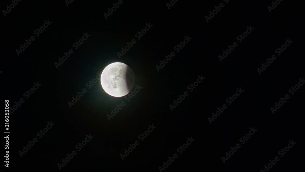 Eclipse Almost Ended. Blood Moon Rising during Lunar Eclipse Surrounded by Mist and Clouds. Eclipse Almost Ended. Blood Moon Rising during Lunar Eclipse Surrounded by Mist and Clouds.