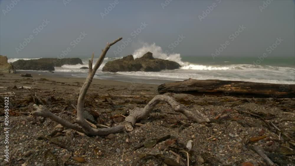 LARGE WAVES POUND A ROUGH COASTLINE. LOW ANGLE, SLOW MOTION, SLIDER SHOT. LARGE WAVES POUND A ROUGH COASTLINE. LOW ANGLE, SLOW MOTION, SLIDER SHOT.