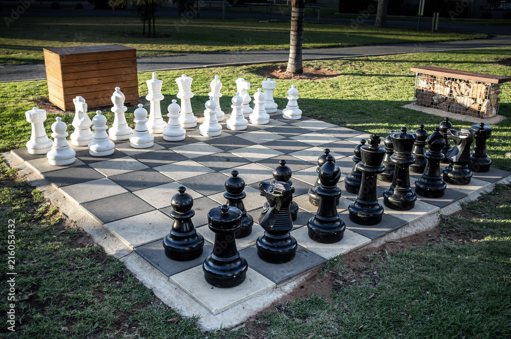 Set of large outdoor chess pieces in correct order to start game in a park  Photos | Adobe Stock