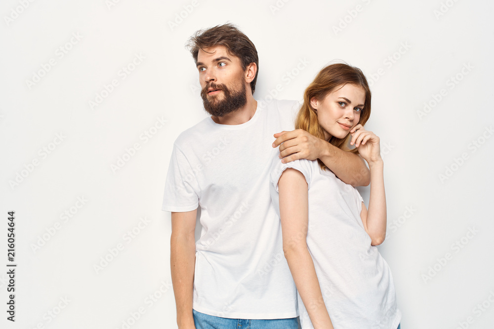 young couple hugging in white in t-shirts young couple hugging in white in t-shirts