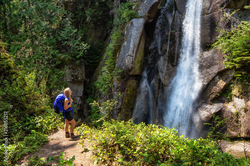 Adventurous woman is hiking in beautiful Canadian Nature during a sunny summer day. Taken in Squamish, North of Vancouver, BC, Canada. © edb3_16