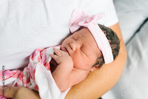 Close up of father holding newborn