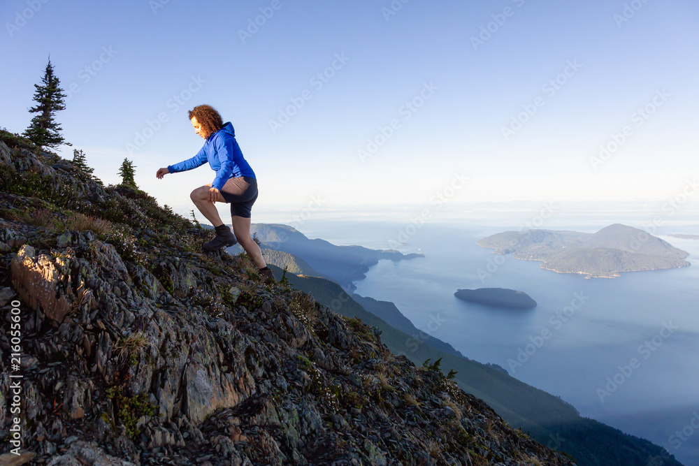 Adventurous woman hiking in the mountains during a sunny summer day. Taken on Mount Brunswick, Lions Bay, North of Vancouver, BC, Canada. Adventurous woman hiking in the mountains during a sunny summer day. Taken on Mount Brunswick, Lions Bay, North of Vancouver, BC, Canada.