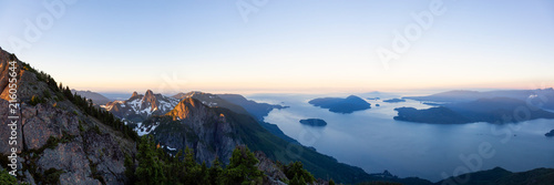 Panoramic landscape view of Howe Sound during a vibrant summer sunrise. Taken from the top of Brunswick Mountain  North of Vancouver  BC  Canada.