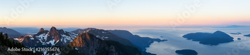 Panoramic landscape view of Howe Sound during a vibrant summer sunrise. Taken from the top of Brunswick Mountain, North of Vancouver, BC, Canada.
