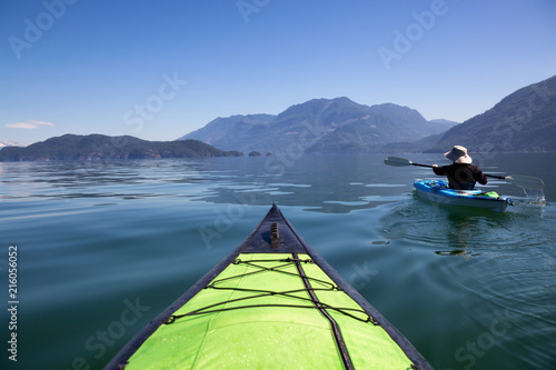 Kayaking in Harrison Lake during a beautiful and vibrant summer day. Located East of Vancouver, British Columbia, Canada.