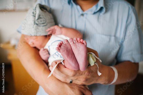 Father holding newborn photo