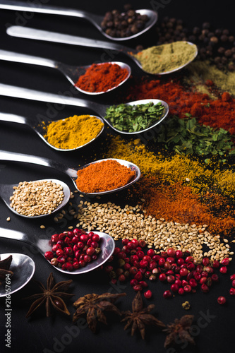 Spices and condiments for cooking on a black background