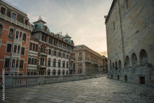 View over cathedral Santo Stefano and traditional style buildings at sunset time at Genoa, Italy