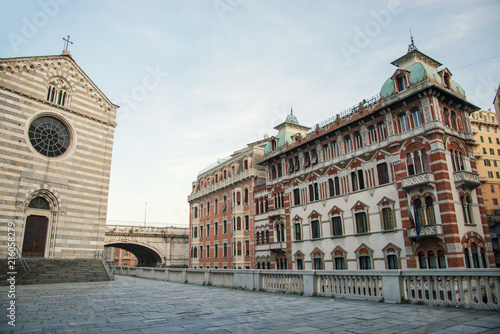 View over cathedral Santo Stefano and traditional style buildings at sunset time at Genoa, Italy