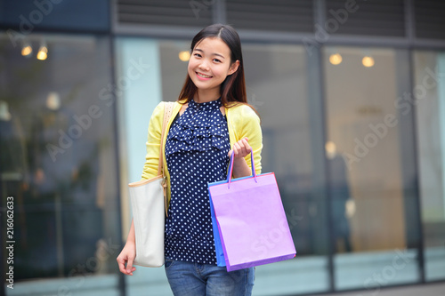 a beautiful young woman shopping happily photo