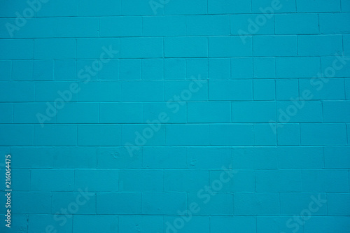 Concrete cinder block wall painted turquoise blue. photo