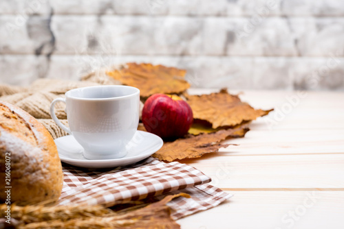 Cup of hot Coffee with toast for Autumn season warm drink. Fall harvest cornucopia. Copy space on wood background. photo