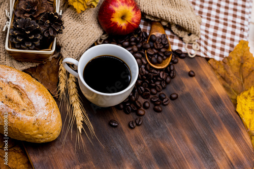 Cup of hot Coffee with toast for Autumn season warm drink. Fall harvest cornucopia. Copy space on wood background. photo