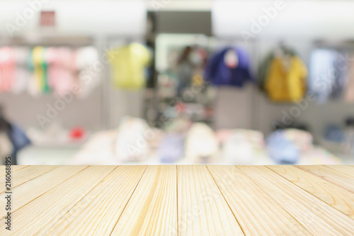 Wallpaper Mural Empty wood table with blur kid fashionable boutique clothing store window display in shopping mall Torontodigital.ca