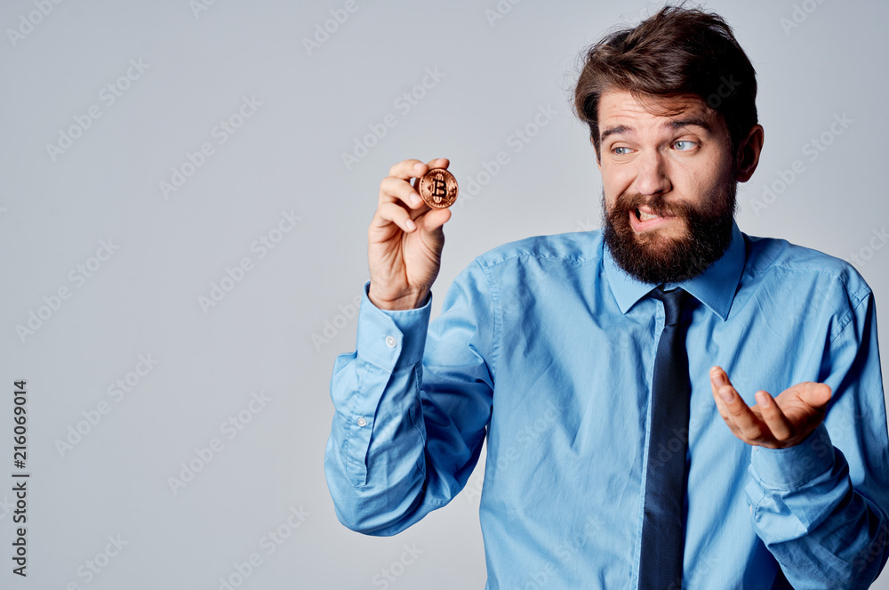 business man with a beard looks at bitcoin finance business man with a beard looks at bitcoin finance