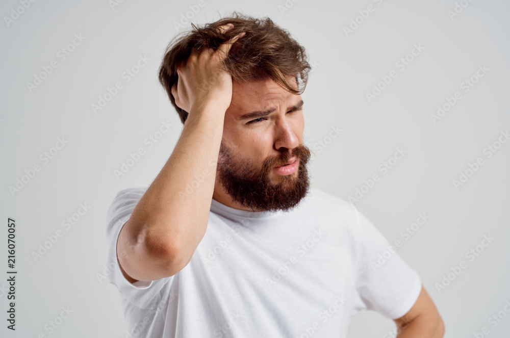 man thinks holds his hand on his head man thinks holds his hand on his head