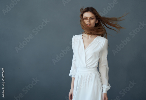woman in a white dress on a gray background © SHOTPRIME STUDIO