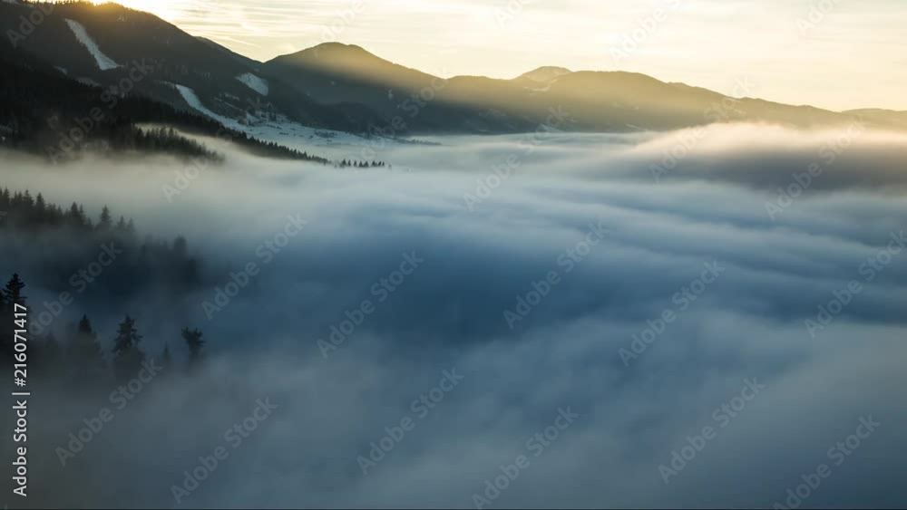 Timelapse over the frozen forest during sunset cloud inversion.
