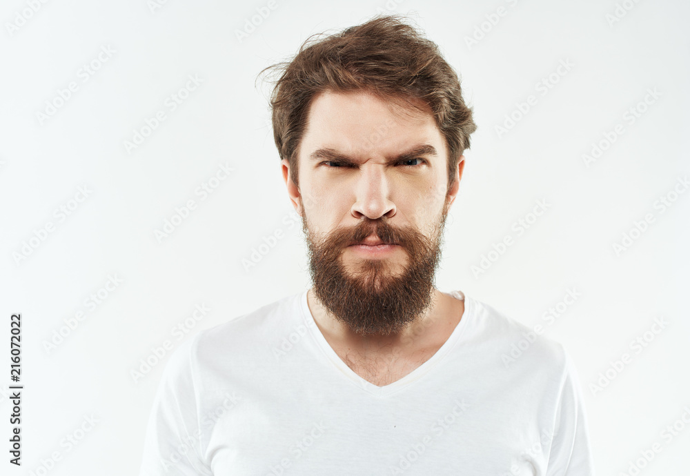 serious man with a beard on a light background portrait serious man with a beard on a light background portrait