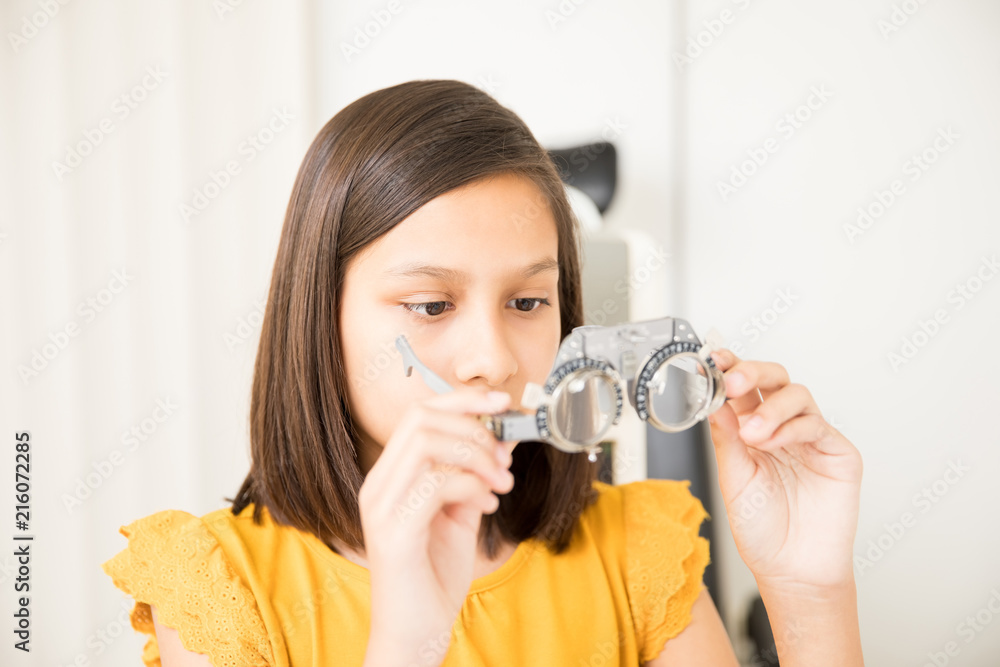 Little girl holding trial frame in hand Little girl holding trial frame in hand